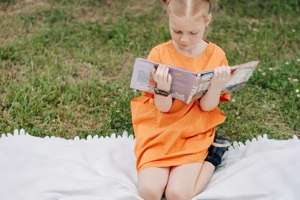 Child reading outside