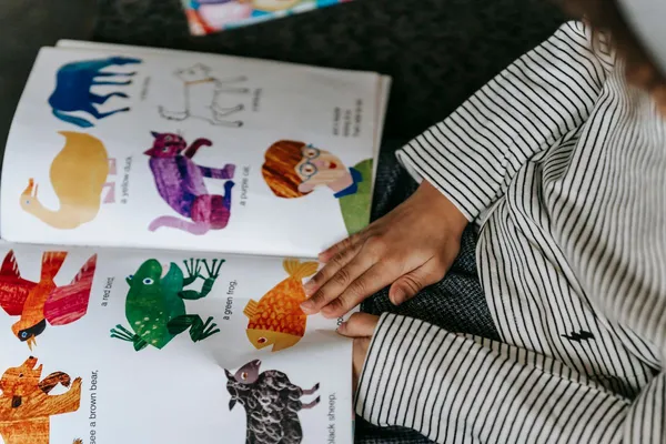 Child reading a colorful book